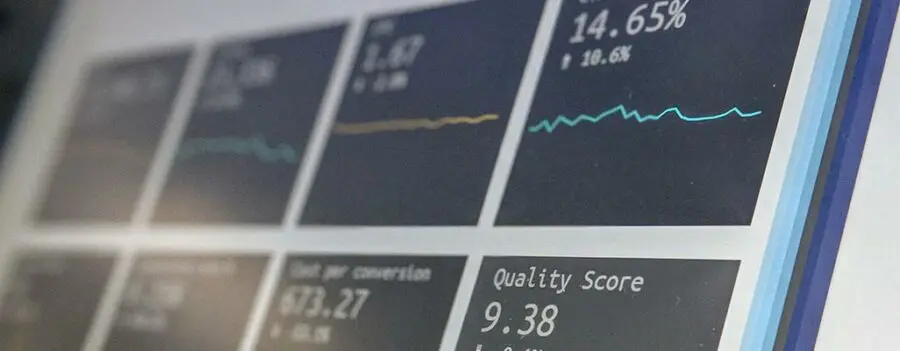 A close-up of a computer screen displaying various data graphs and performance metrics, including percentage rates and a quality score, showcases advanced software for storage units used in efficient storage facility management.