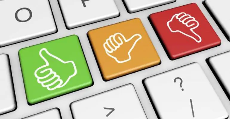 Close-up of a keyboard with green, yellow, and red keys showing thumbs up, sideways, and down icons—perfect for managing feedback in storage unit management or self storage software interfaces.