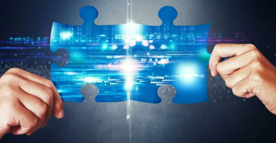 Two hands hold a large puzzle piece with a digital, futuristic pattern and glowing blue lights—symbolizing innovative storage facility management solutions against a dark background.
