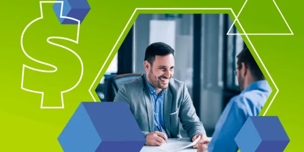 Two men in business attire sit across from each other at a desk, discussing software for storage units, with geometric shapes and a dollar sign in the background.