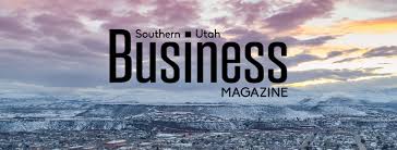 Skyline view of a city with snow-covered mountains at sunset, overlaid with the text "Southern Utah Business Magazine" and featuring insights on self storage software for modern storage facility management.