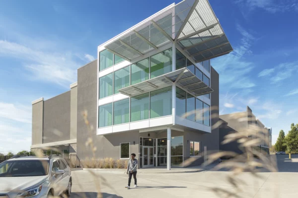 A concept of a modern, large, 3-story, glass-walled storage facility.